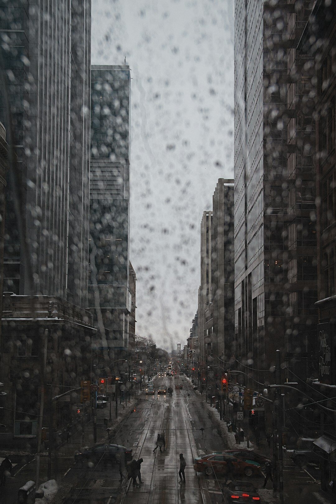person walking in rainy city
