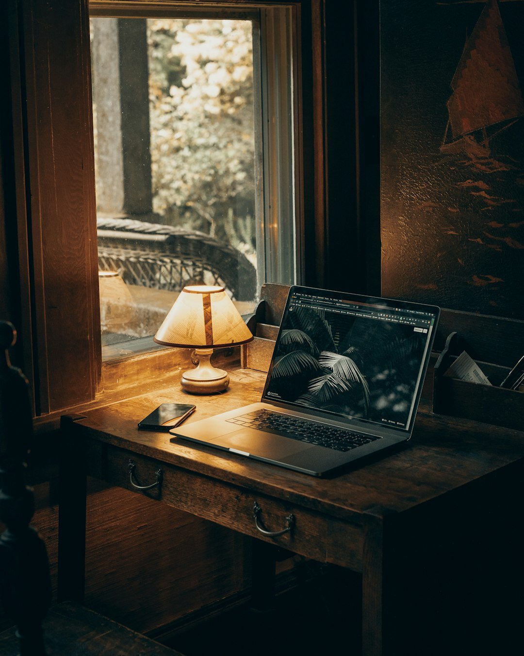 mystery writer at desk with lamp