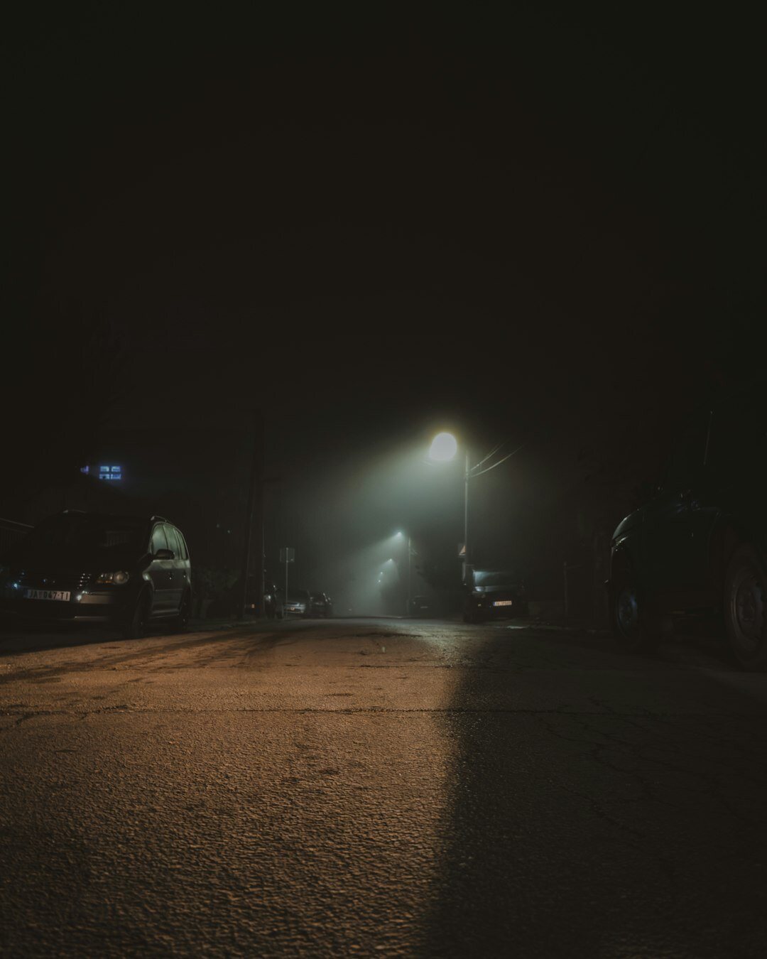 Foggy cobblestone street in an old Croatian coastal town at night